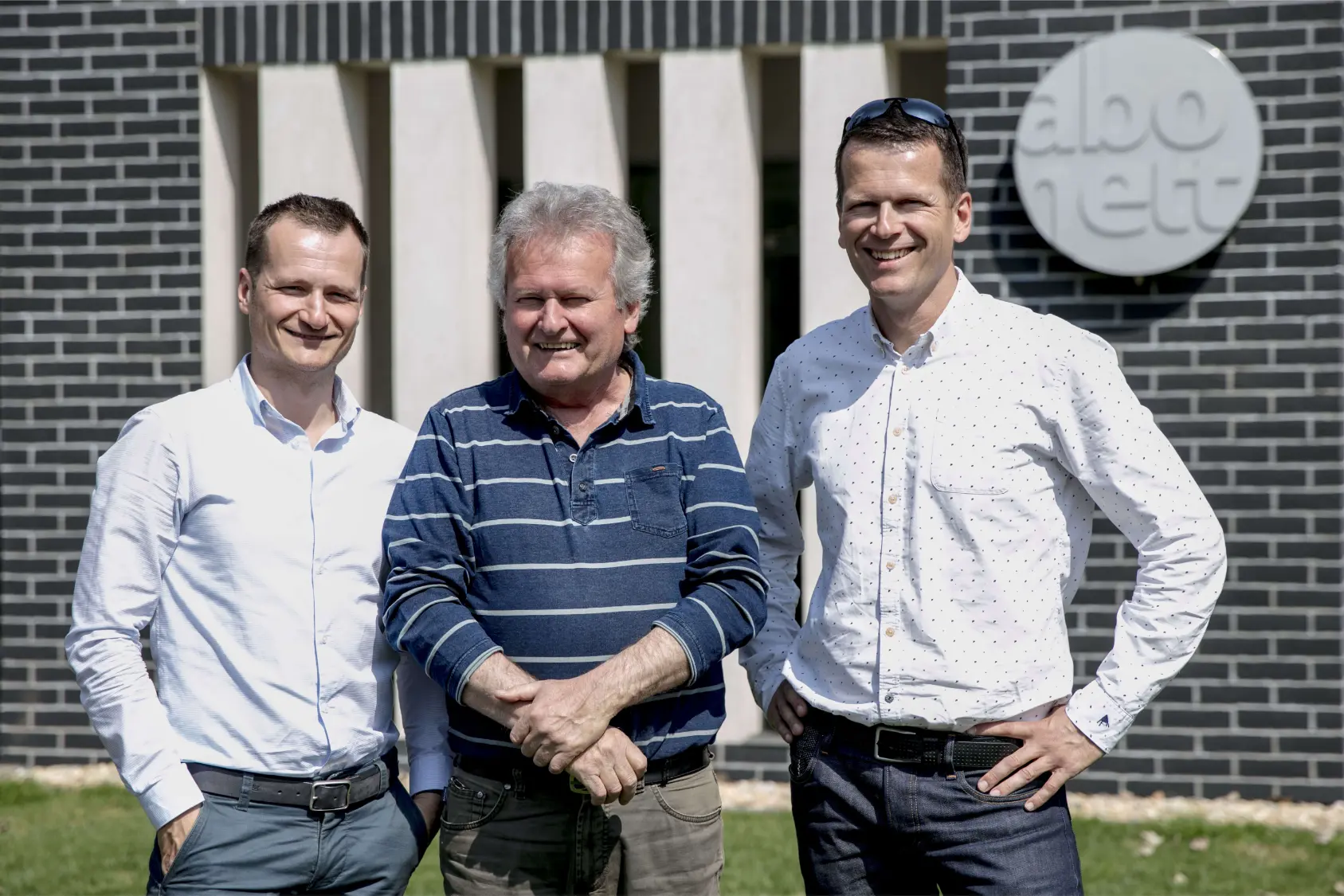 Zoltán Szebeni with his sons Zoltán and Ákos in front of the Abonett plant