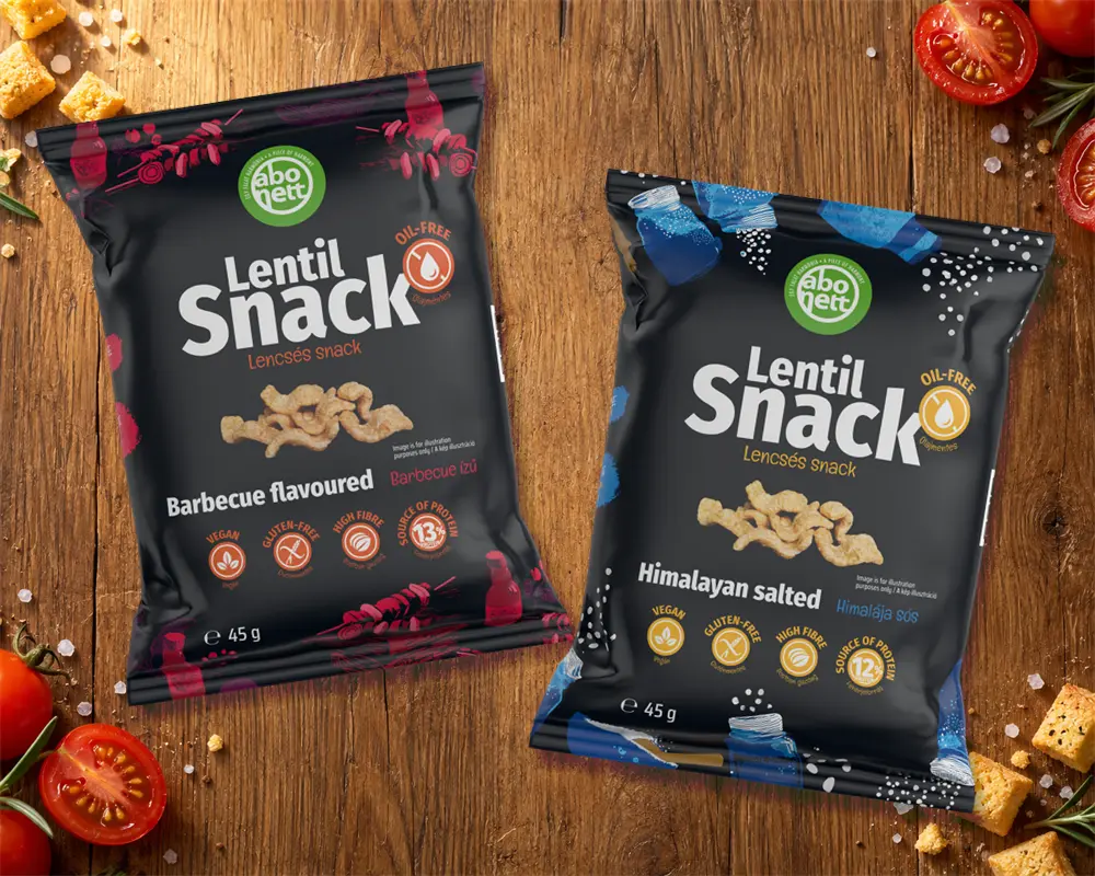Barbecue and Himalayan Salted Lentil Snack bags on a wooden table with tomatoes